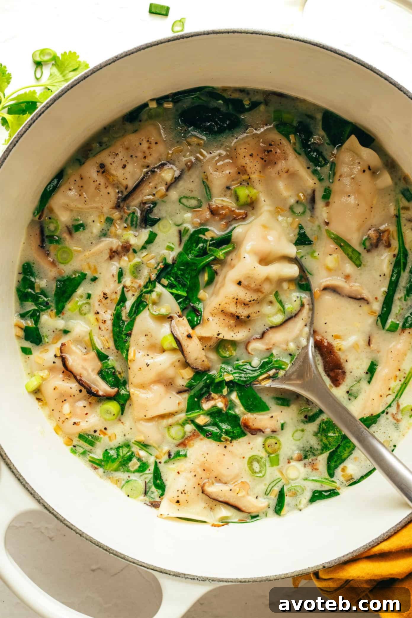 Ginger Coconut Potsticker Soup Simmering in a Stockpot