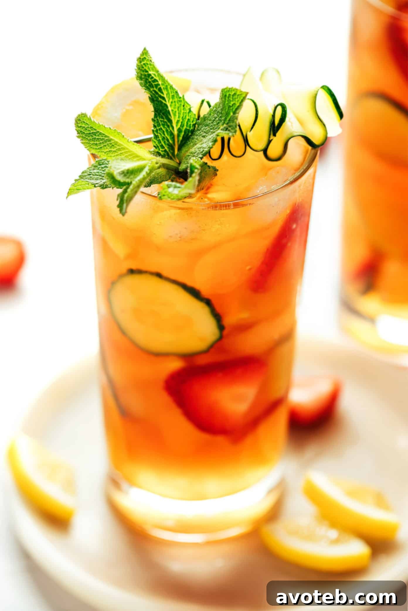 A final close-up of a Pimm's Cup cocktail with vibrant fruit, cucumber, and mint, ready to be enjoyed