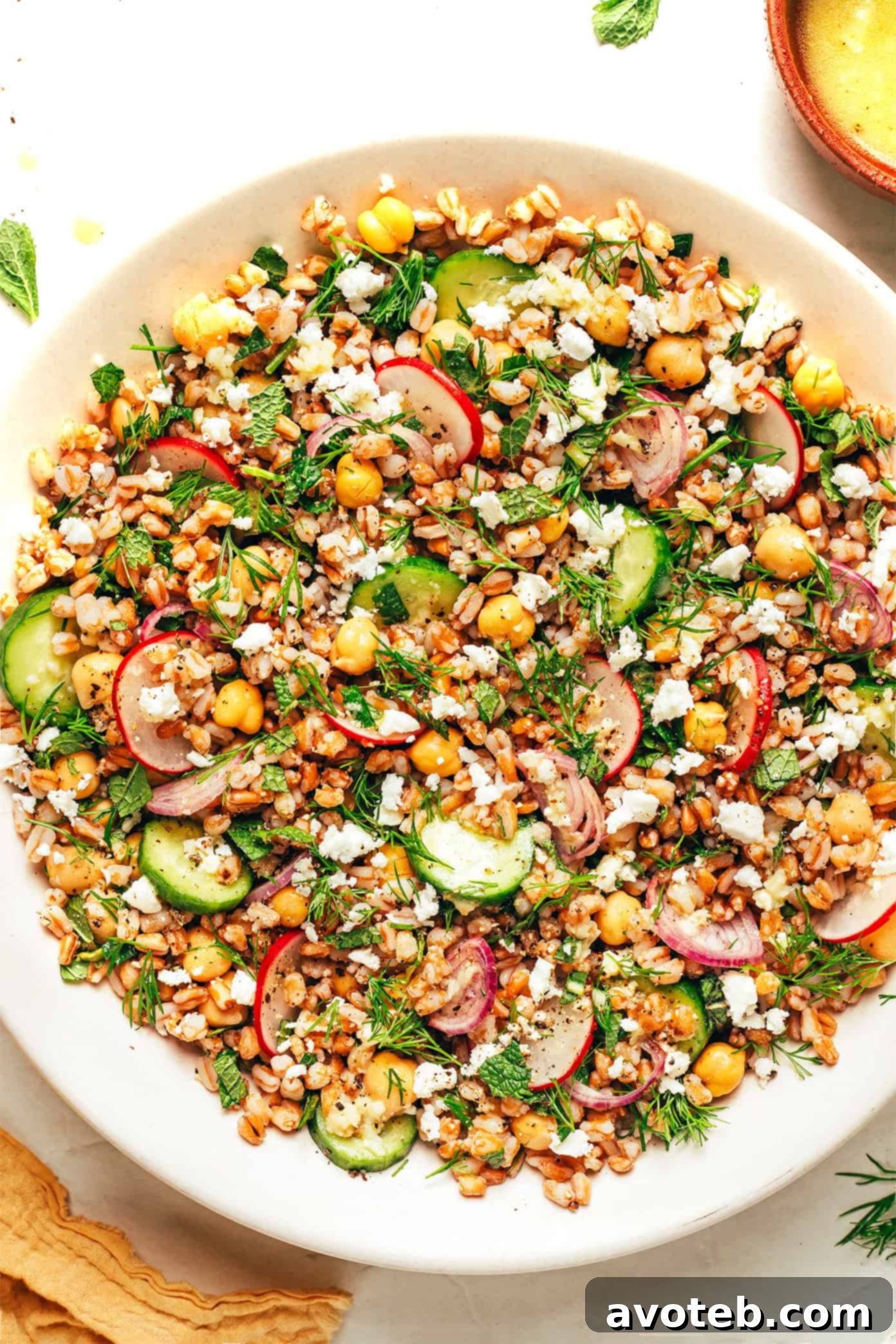 Vibrant Spring Farro Salad 5 A close-up of the Spring Farro Salad, emphasizing the fresh herbs like dill and mint, alongside the vibrant chickpeas, farro, and various chopped vegetables.