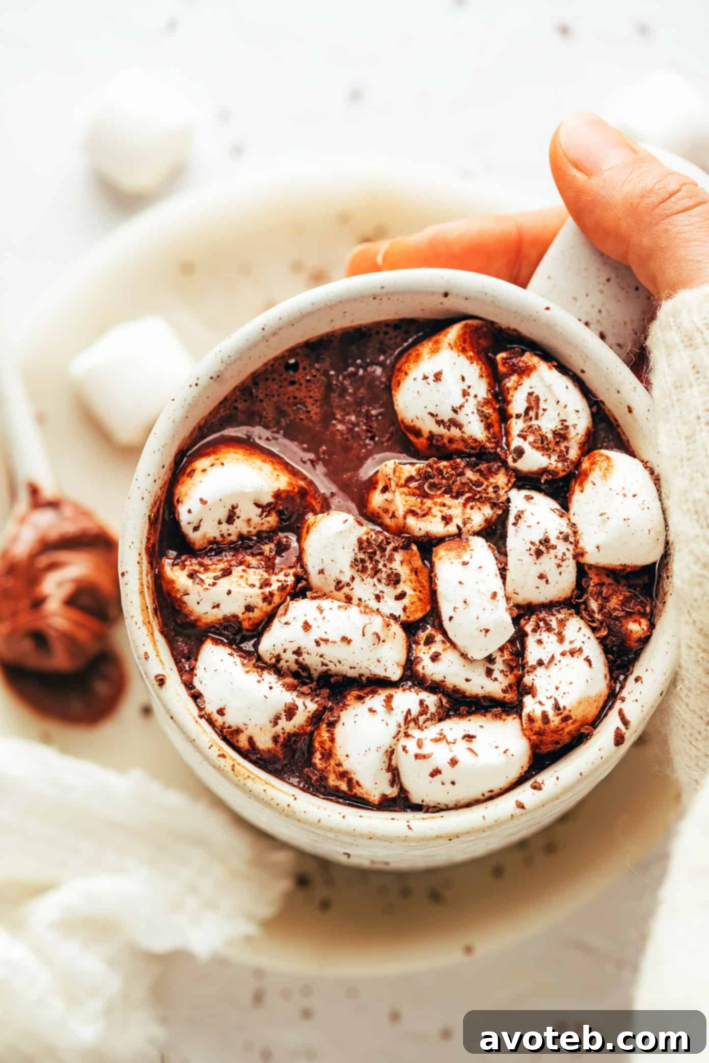 A collection of hot chocolate mugs with various toppings.