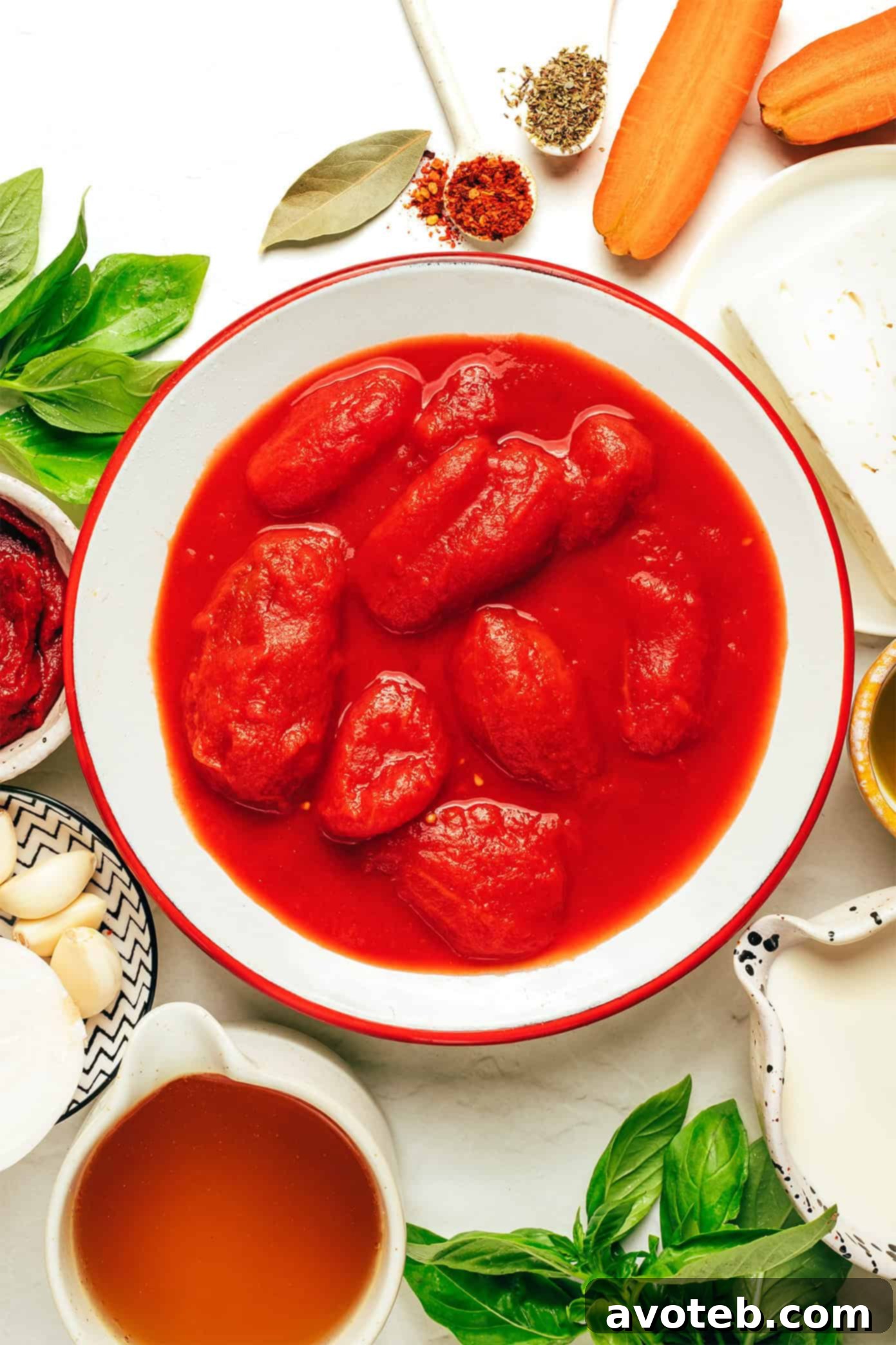 A close-up shot of creamy tomato feta soup with a generous swirl of cream and fresh basil leaves, inviting a taste.