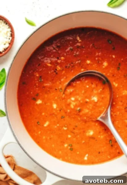 Homemade Tomato Feta Soup, garnished with fresh basil and crumbled feta