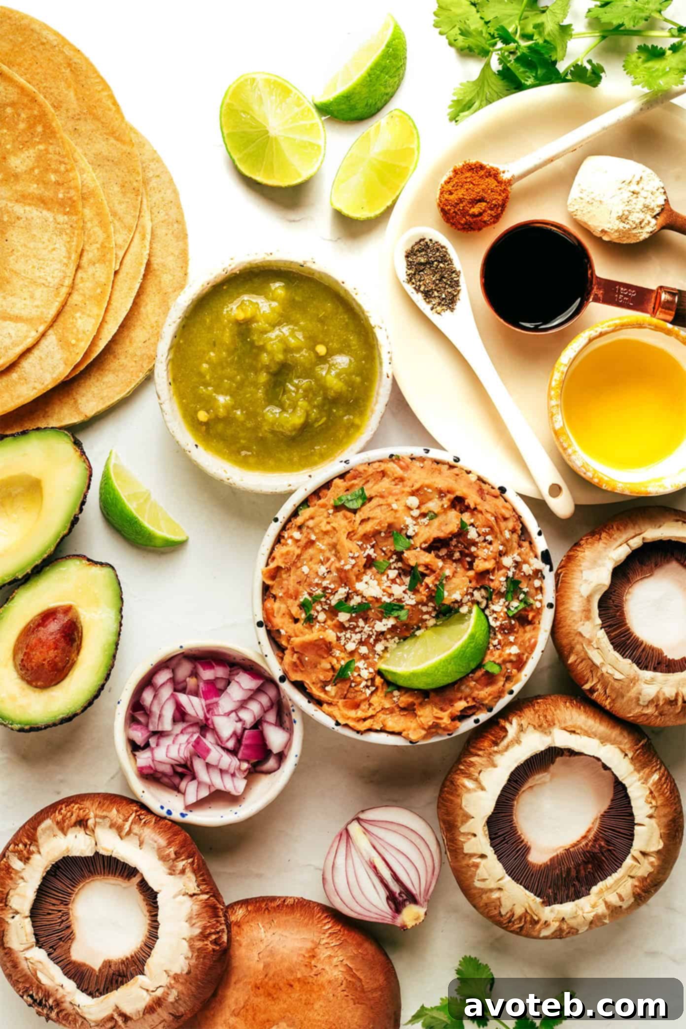 Two Portobello Mushroom Tacos with fresh toppings on a wooden board.