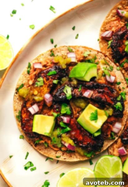 Two Portobello Tacos presented on a serving board with various fresh ingredients.