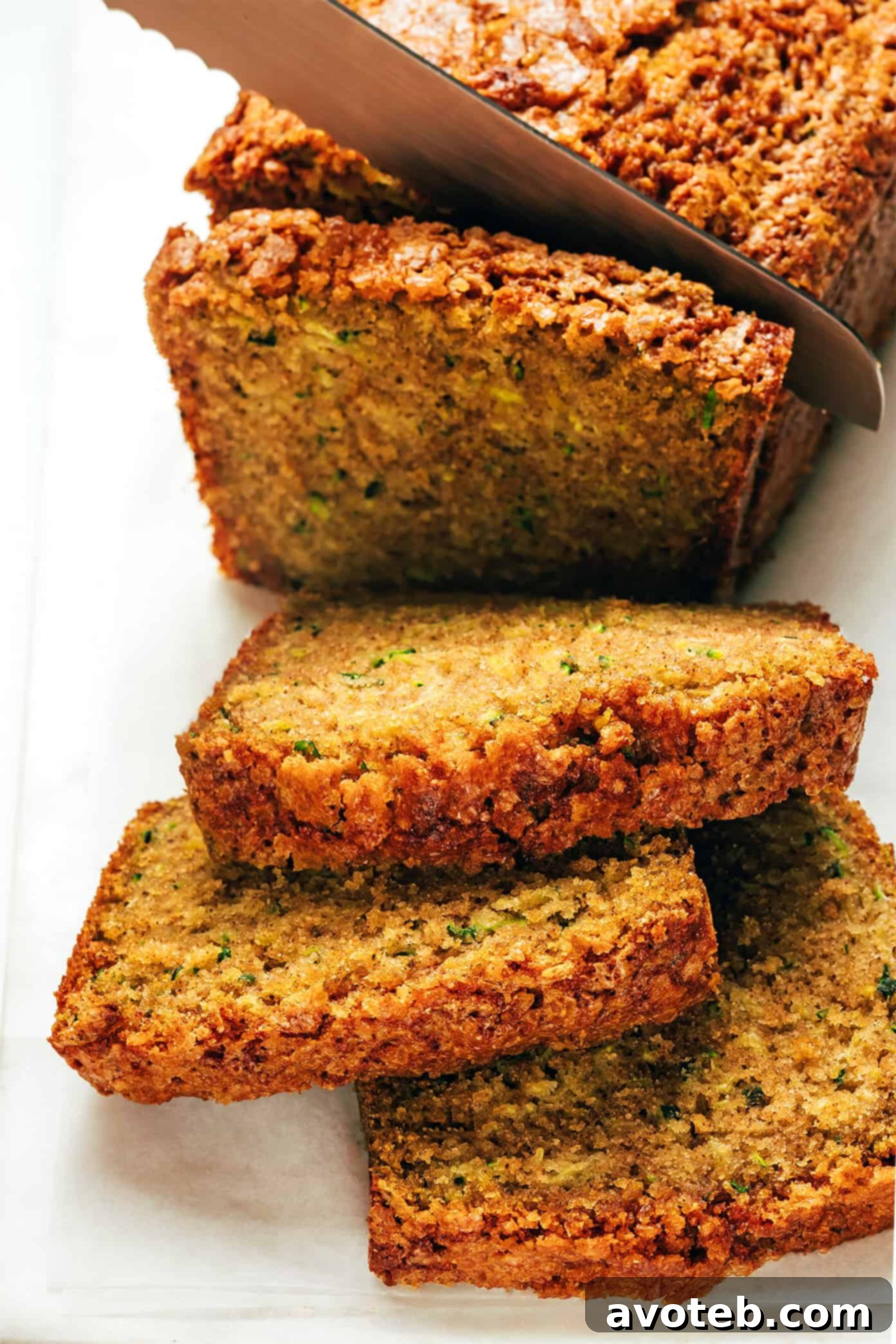 Freshly baked zucchini bread slice with a crunchy sugar topping