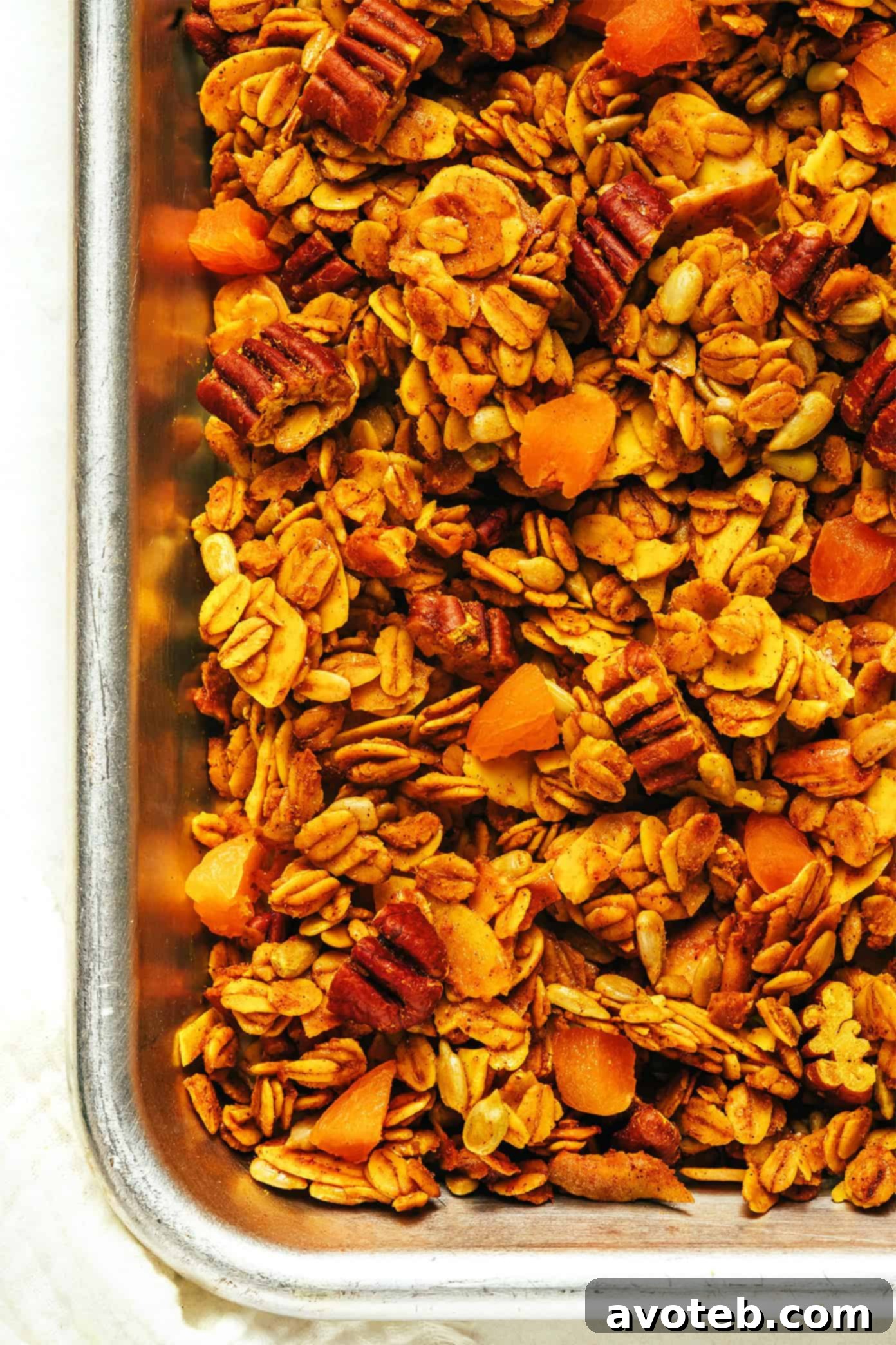 Golden Granola in a small bowl with a spoon, ready to eat