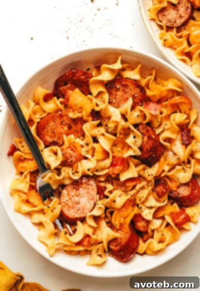 A beautifully presented bowl of Kielbasa Cabbage Noodles, garnished and ready to serve.