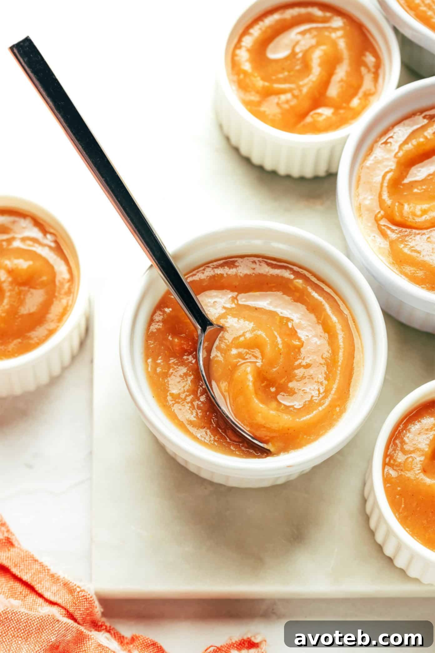 Glass jars filled with homemade applesauce, ready for storage