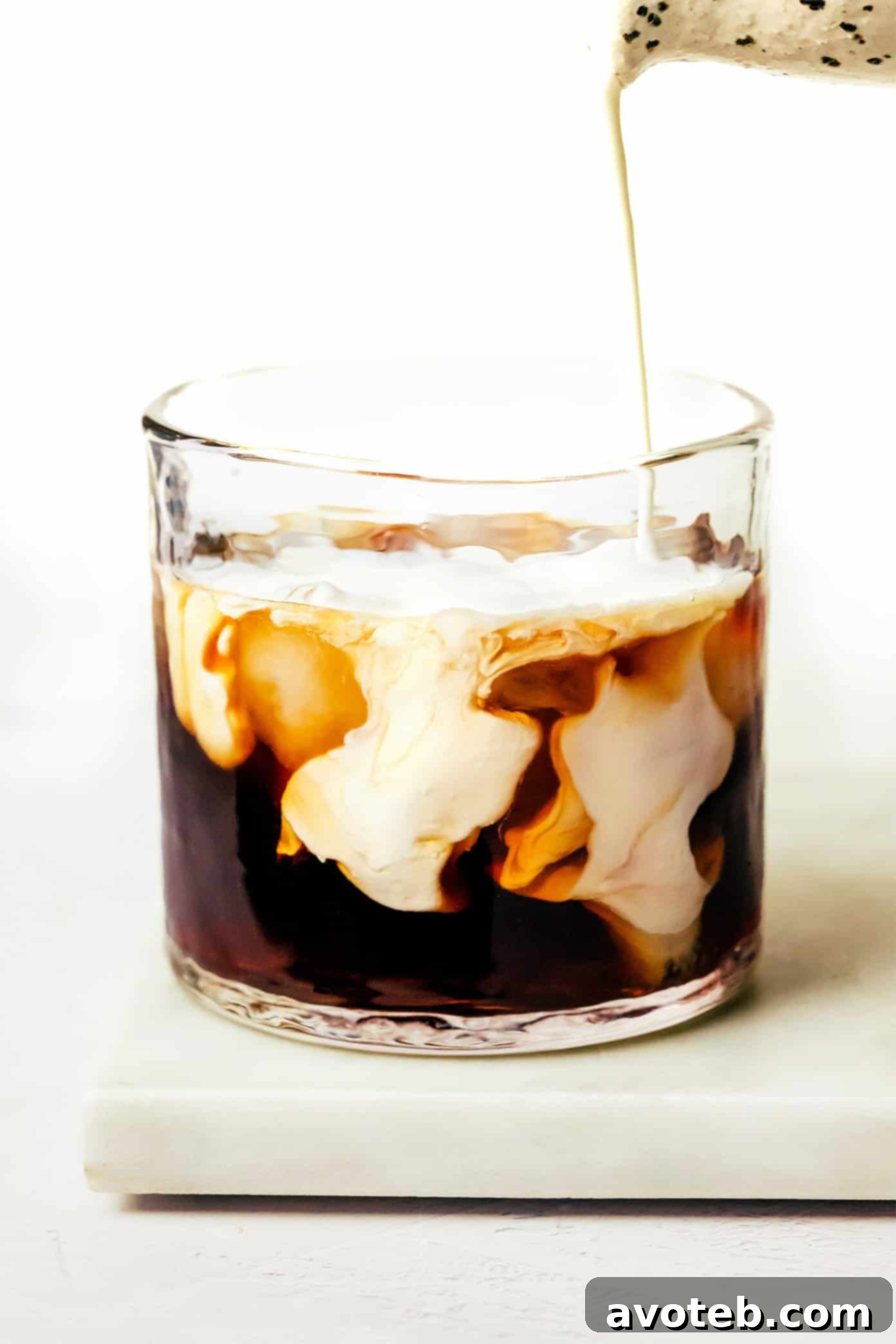 A perfectly prepared White Russian cocktail in a rocks glass with ice