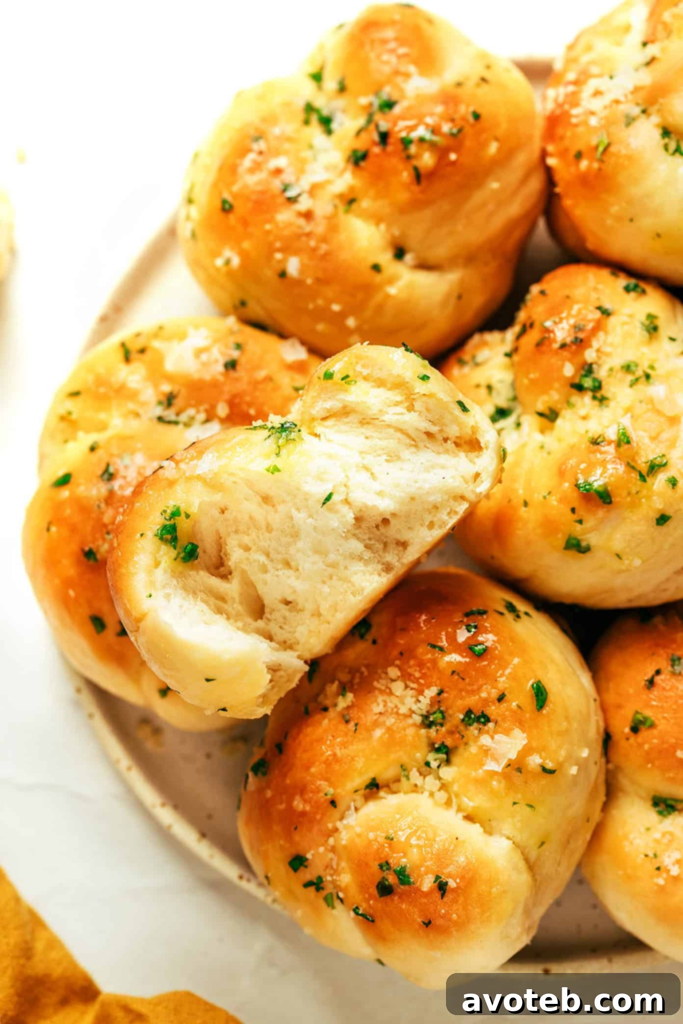 A generous serving of garlic knots on a rustic wooden board, ready to be enjoyed.
