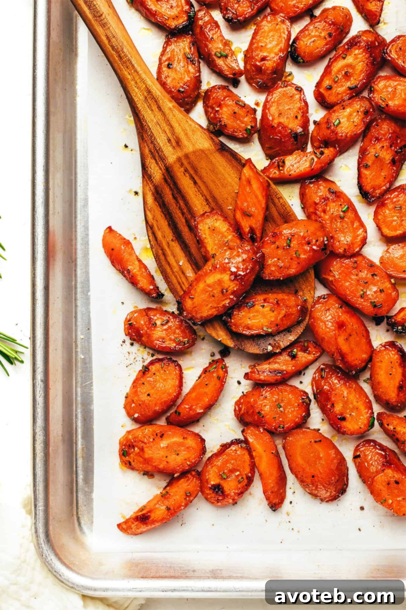 Perfectly roasted carrots with honey butter glaze, sprinkled with rosemary and flaky sea salt, served on a rustic board.