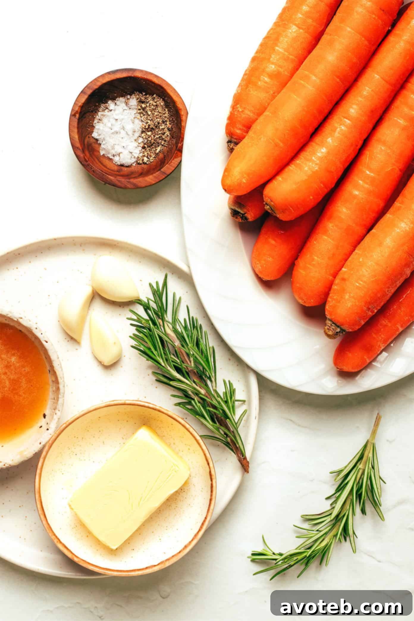 Close-up of roasted carrots on a baking sheet, glistening with honey butter glaze.
