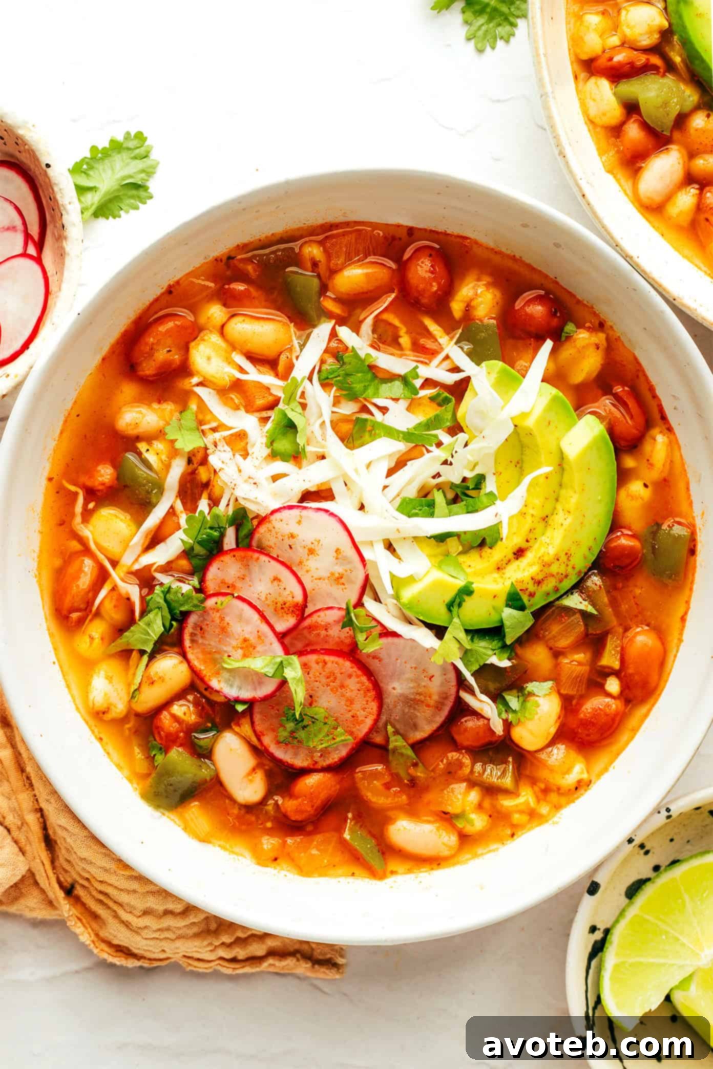 A final overhead shot of a perfectly garnished bowl of vegetarian pozole, ready to be enjoyed.