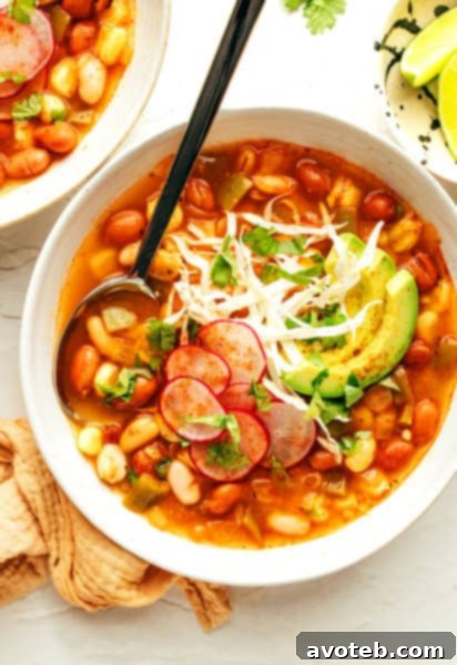 Vegetarian Pozole garnished with cilantro, avocado, and radishes.