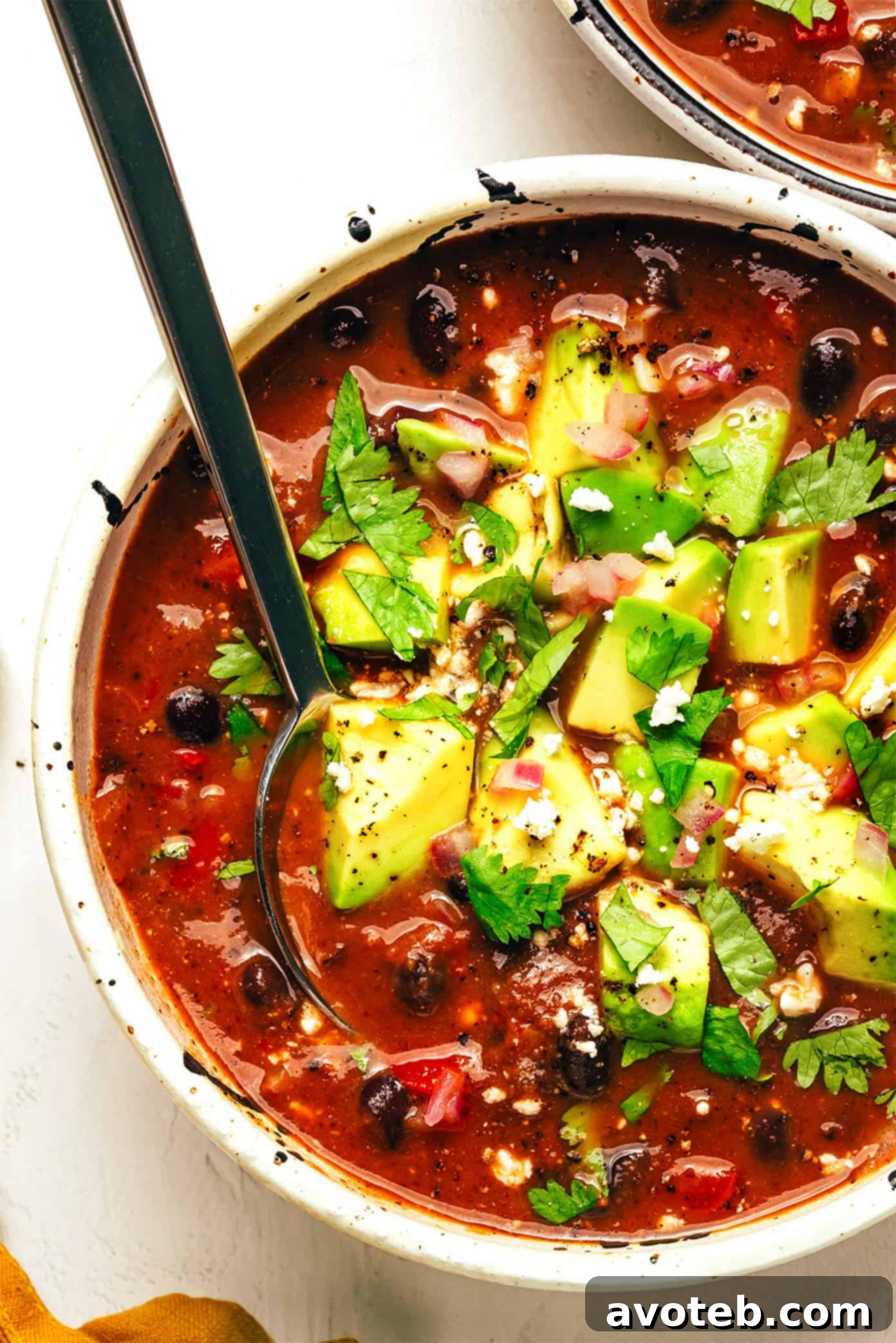 Delicious Black Bean Soup ready to eat with fresh toppings