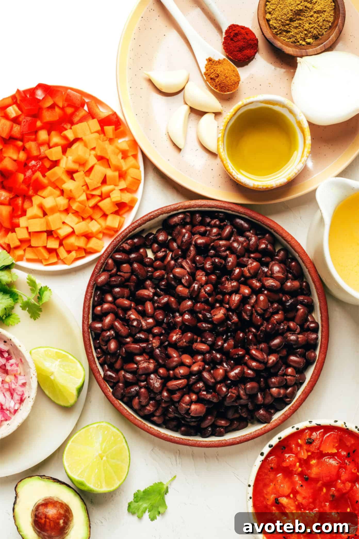 Fresh ingredients laid out for making black bean soup, including beans, vegetables, and spices