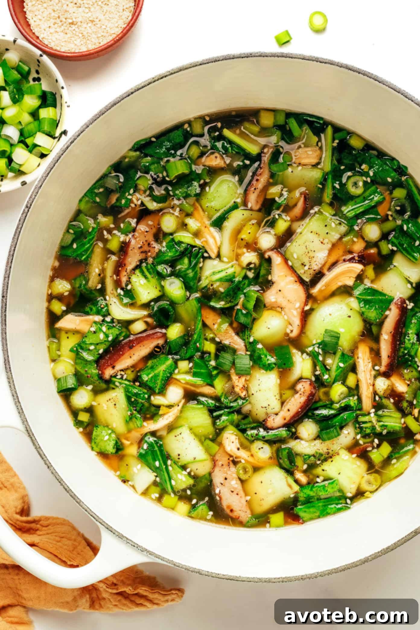 A close-up of ginger scallion chicken soup in a bowl, showcasing the rich broth and vibrant vegetables.