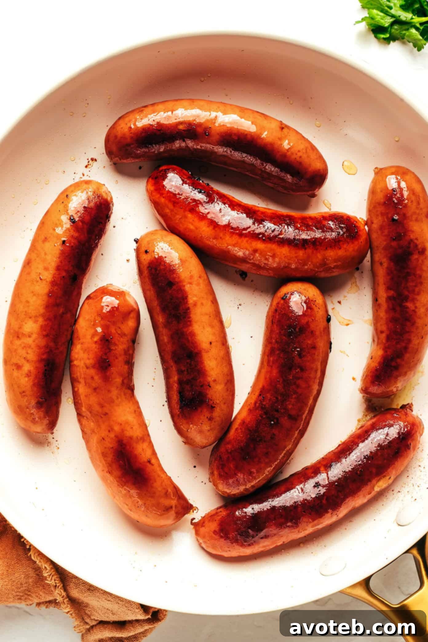 Close-up of golden-brown sausages on a serving platter, ready to be paired with mashed potatoes and gravy.
