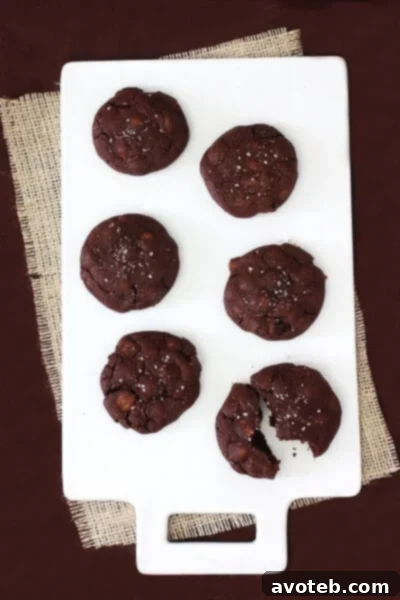 Close-up of a freshly baked Salted Caramel Chocolate Cookie, showing its rich texture and melted caramel
