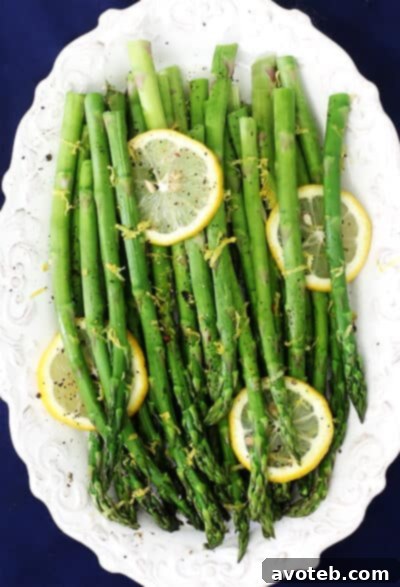 Close-up of vibrant green lemon pepper asparagus spears, ready to be served.