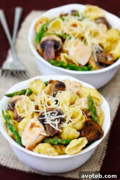 Pasta With Goat Cheese, Chicken, Asparagus & Mushrooms | gimmesomeoven.com A rustic, dimly lit photo of a bowl of pasta with chicken, asparagus, and mushrooms, reflecting early food photography styles.