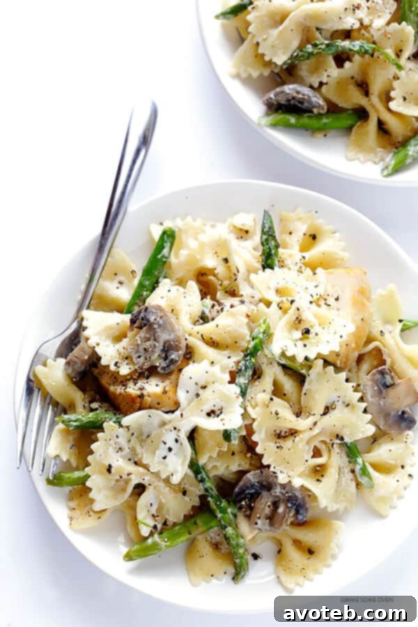 Chevre Chicken Pasta with Asparagus and Sautéed Mushrooms 4 A side view of the goat cheese pasta, highlighting the textures of the pasta, chicken, asparagus, and mushrooms, all coated in the creamy sauce.