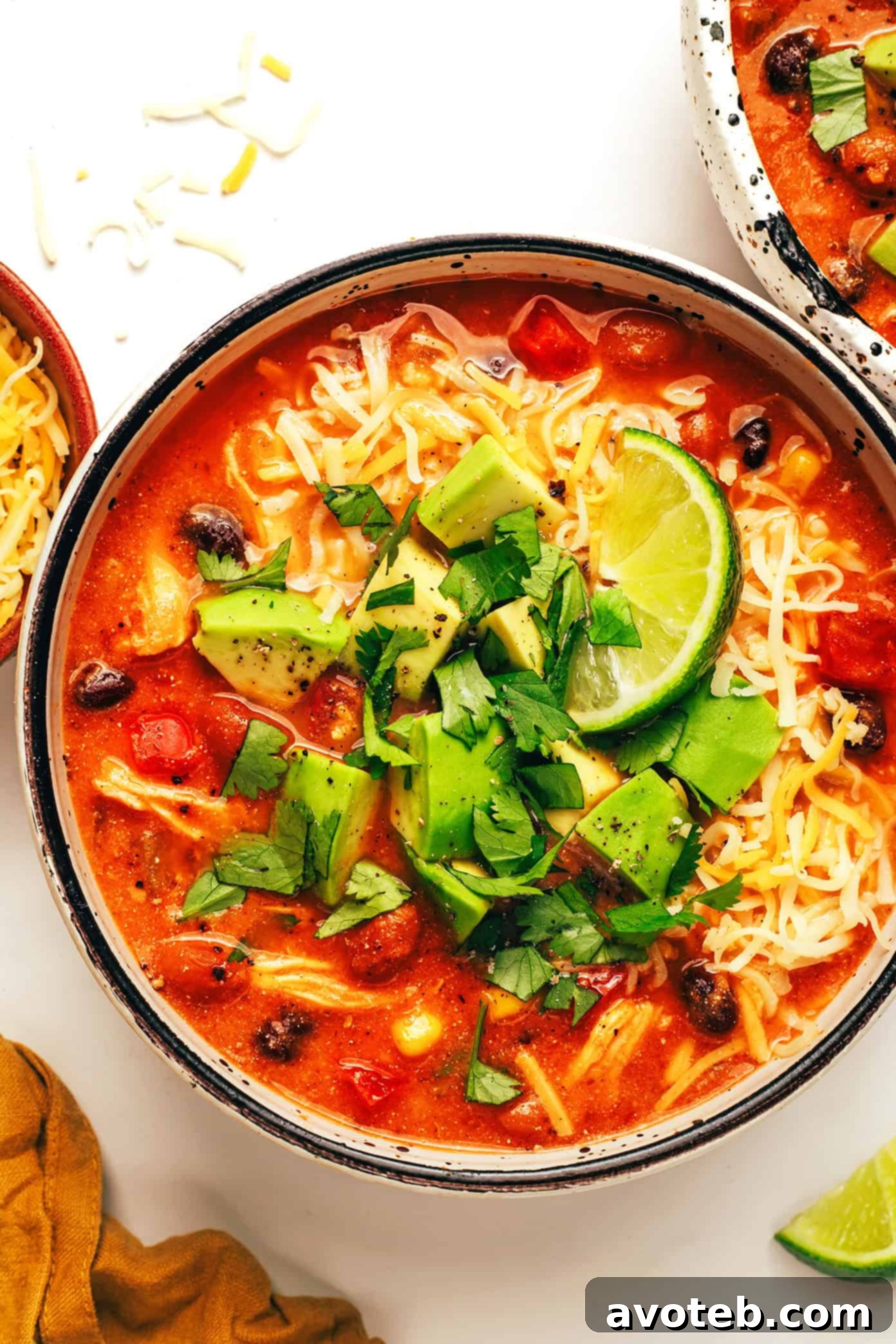 Lean & Mean Chicken Chili 2 A bowl of creamy white chicken chili topped with fresh cilantro and a lime wedge.