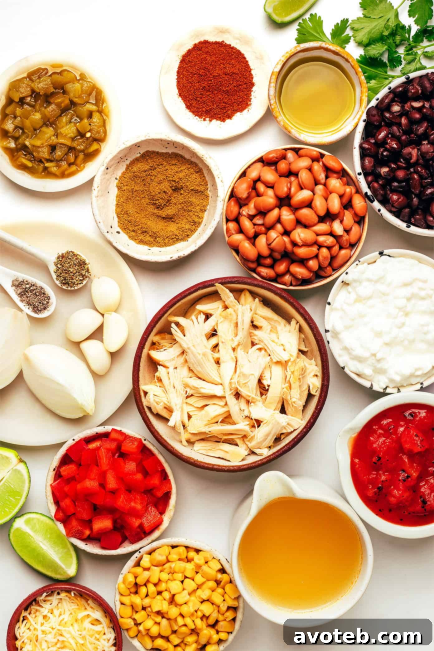 Lean & Mean Chicken Chili 3 Ingredients for high-protein chicken chili laid out on a wooden board.
