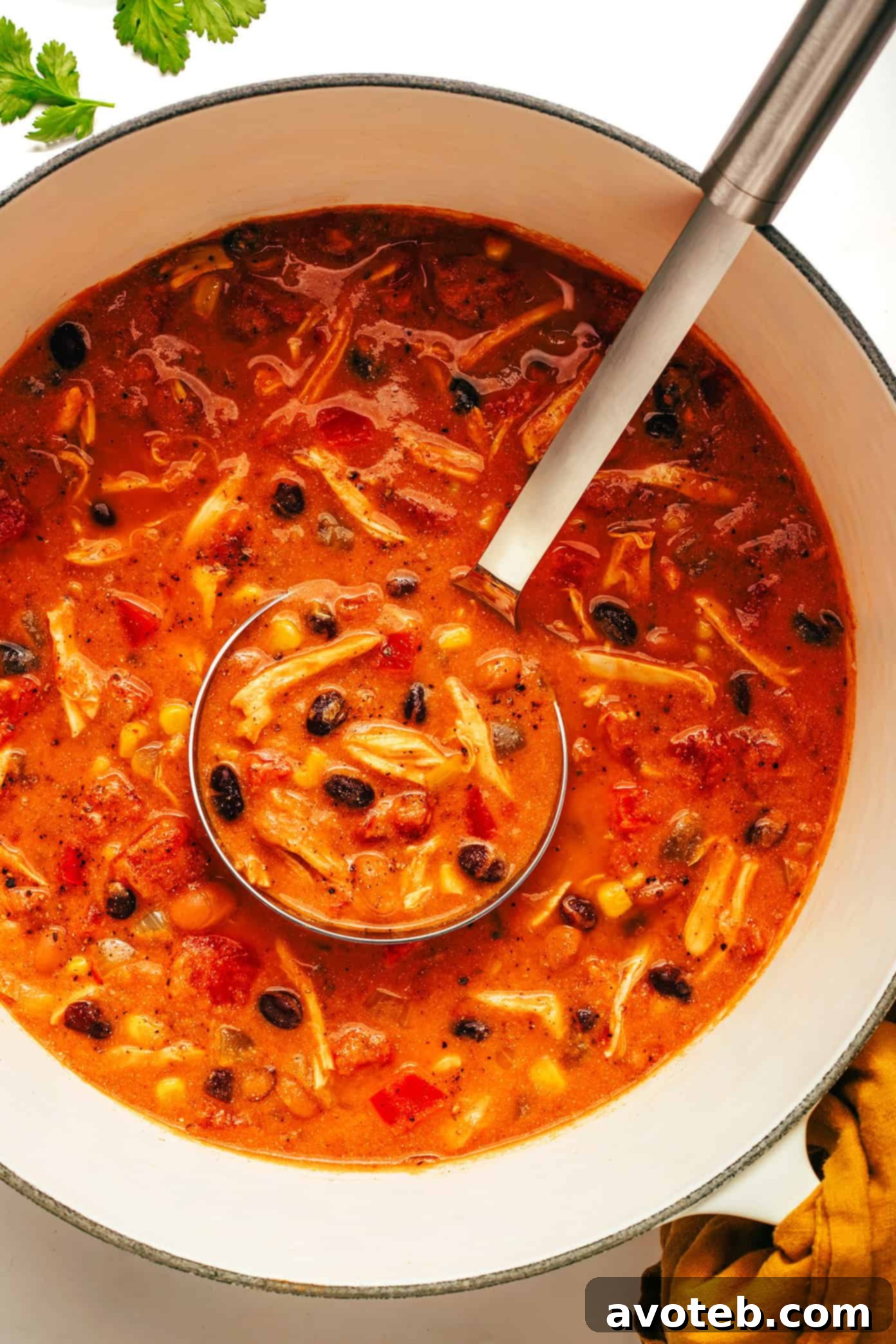 Lean & Mean Chicken Chili 5 Close-up of high-protein chicken chili with a spoonful being lifted.