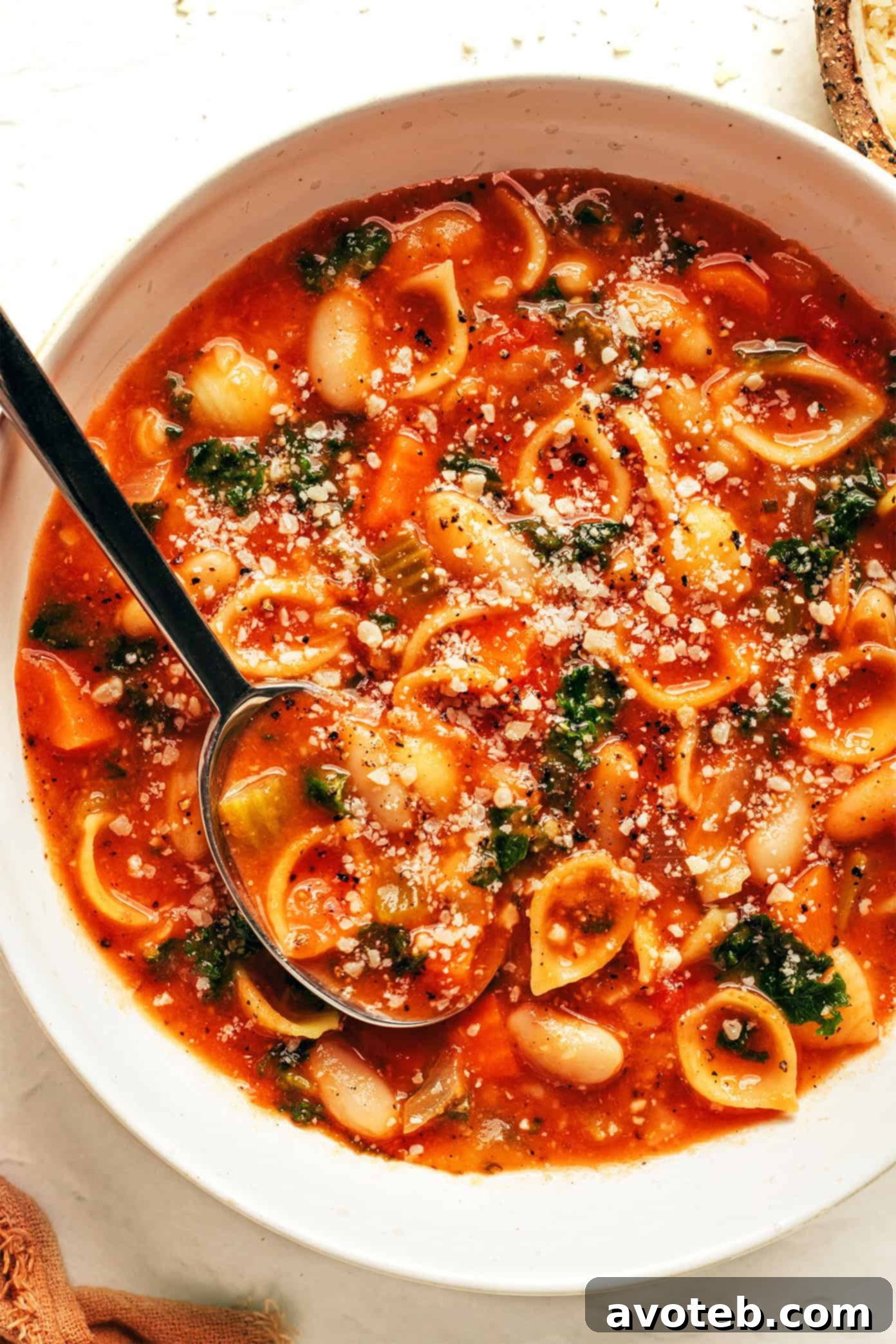 A final close-up shot of a rustic bowl of Pasta e Fagioli with a spoon, inviting you to enjoy its hearty goodness.