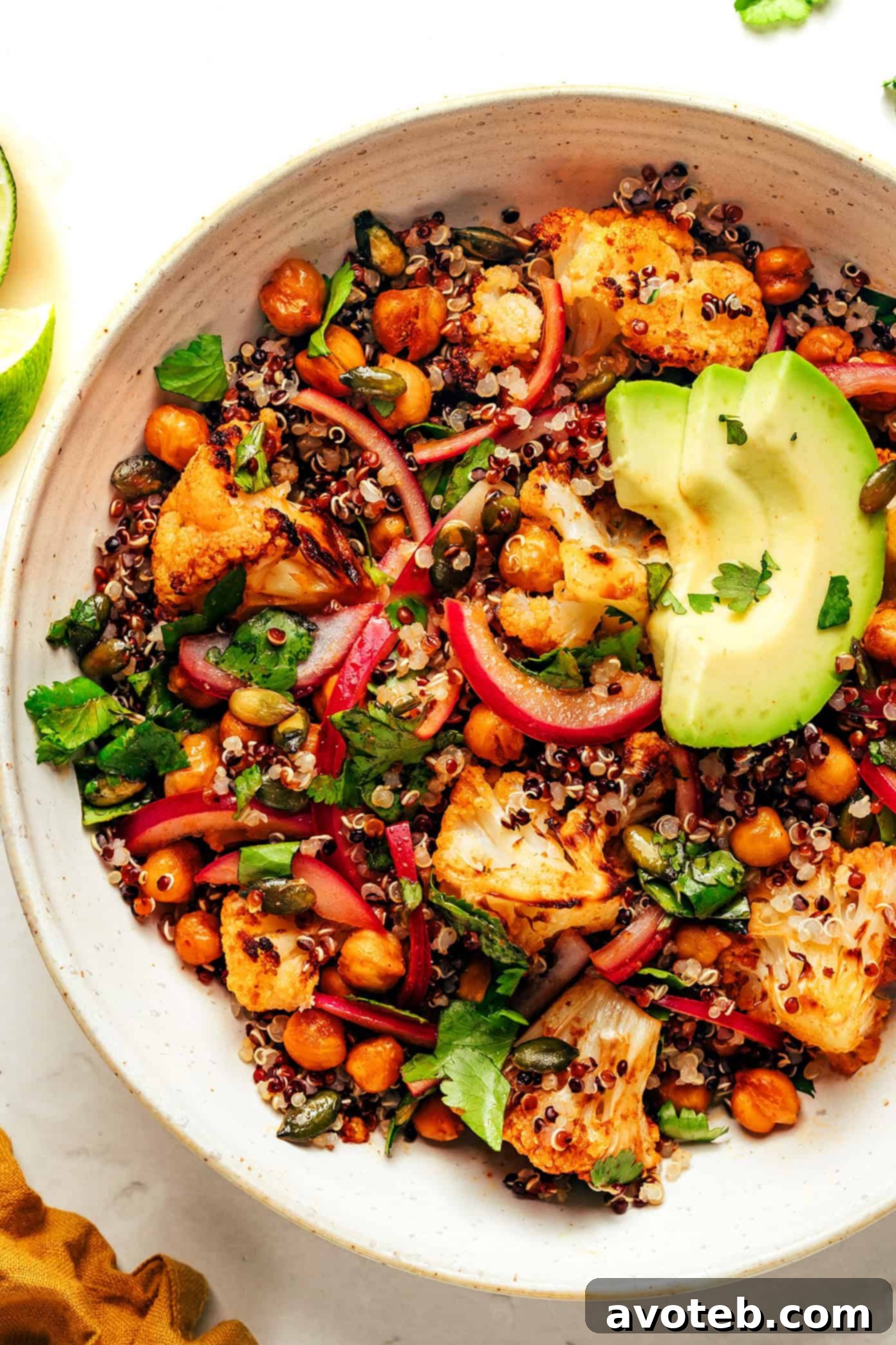 Top-down view of a vibrant Chili-Lime Roasted Cauliflower, Chickpea, and Quinoa Bowl