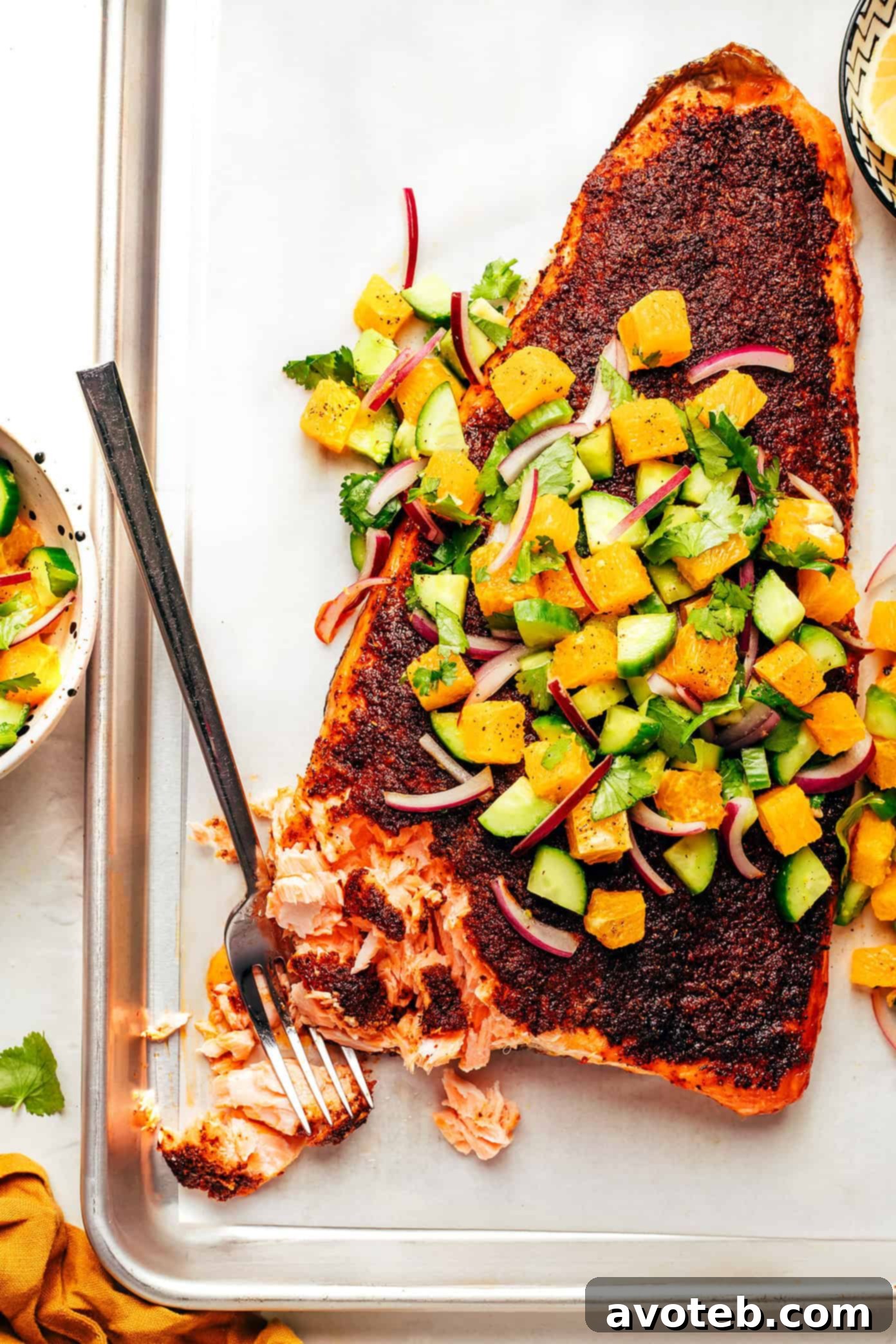 Zesty Sumac Salmon with Vibrant Citrus Salsa 5 Sumac-blackened salmon being removed from the oven, showing a perfectly cooked crust.