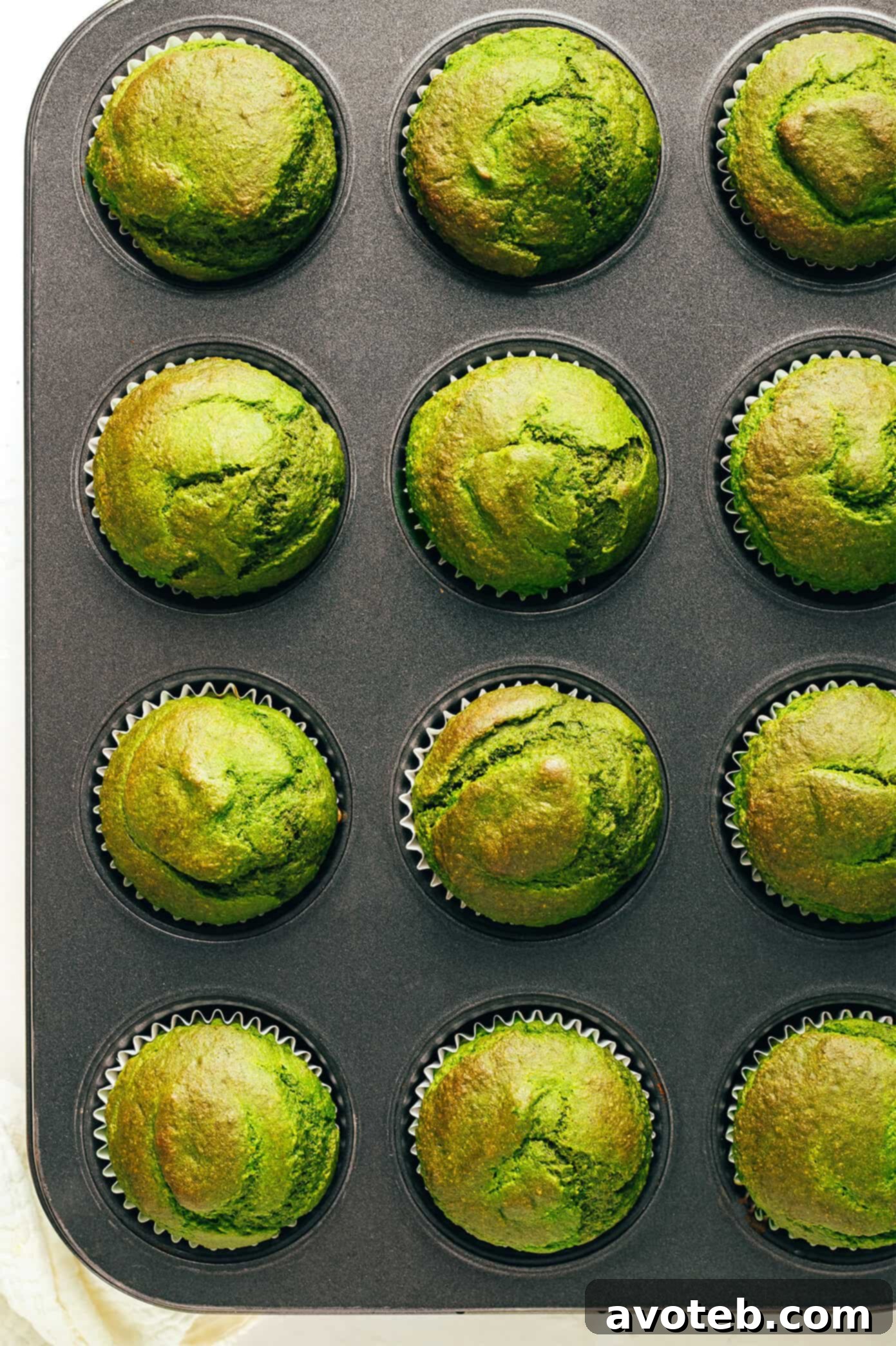 Baked green spinach banana muffins in a muffin pan