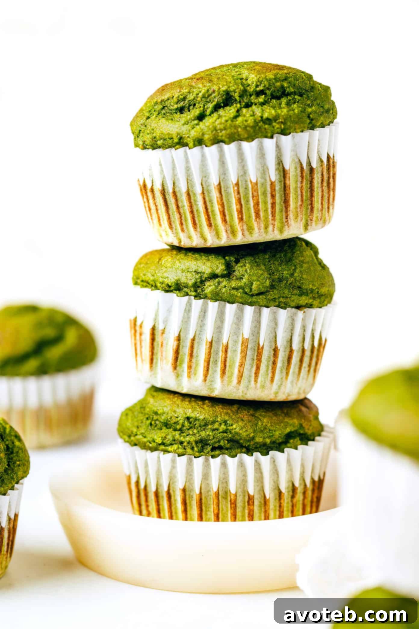 Stack of green spinach banana muffins on a plate