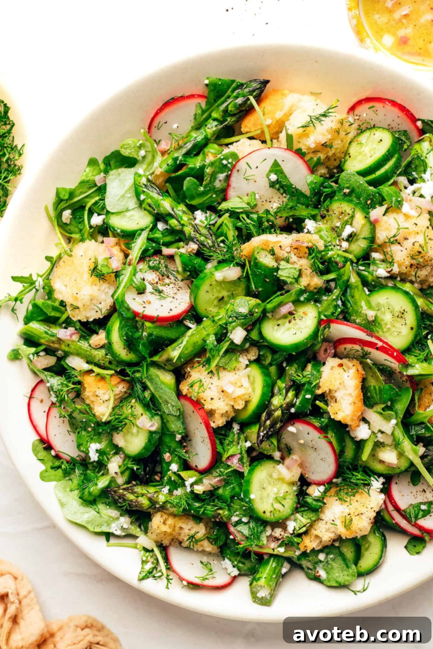 Spring Panzanella with Sourdough Croutons on a light background