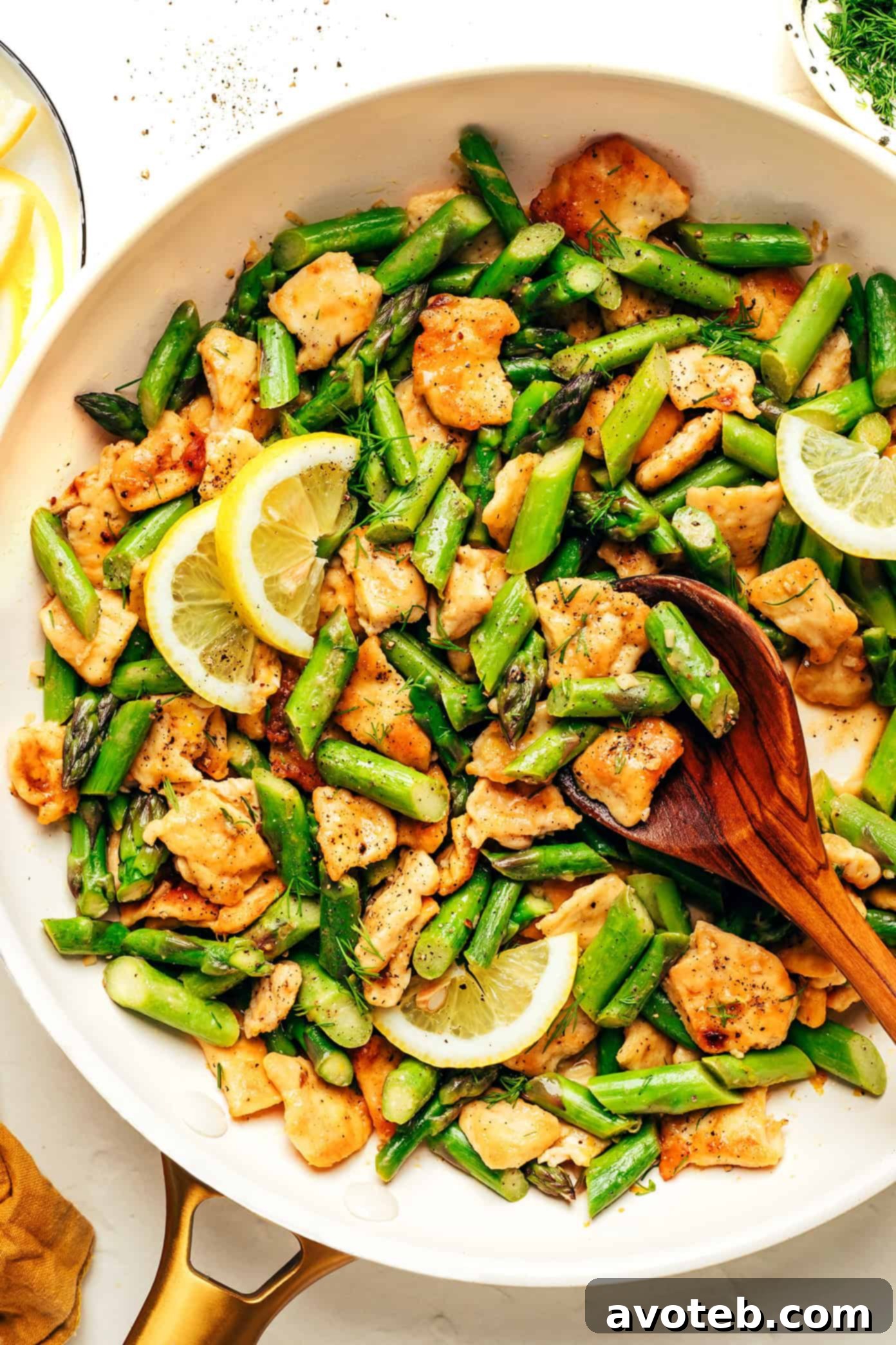 Lemon Pepper Chicken Asparagus Stir-Fry in a skillet, showcasing tender chicken and vibrant asparagus.