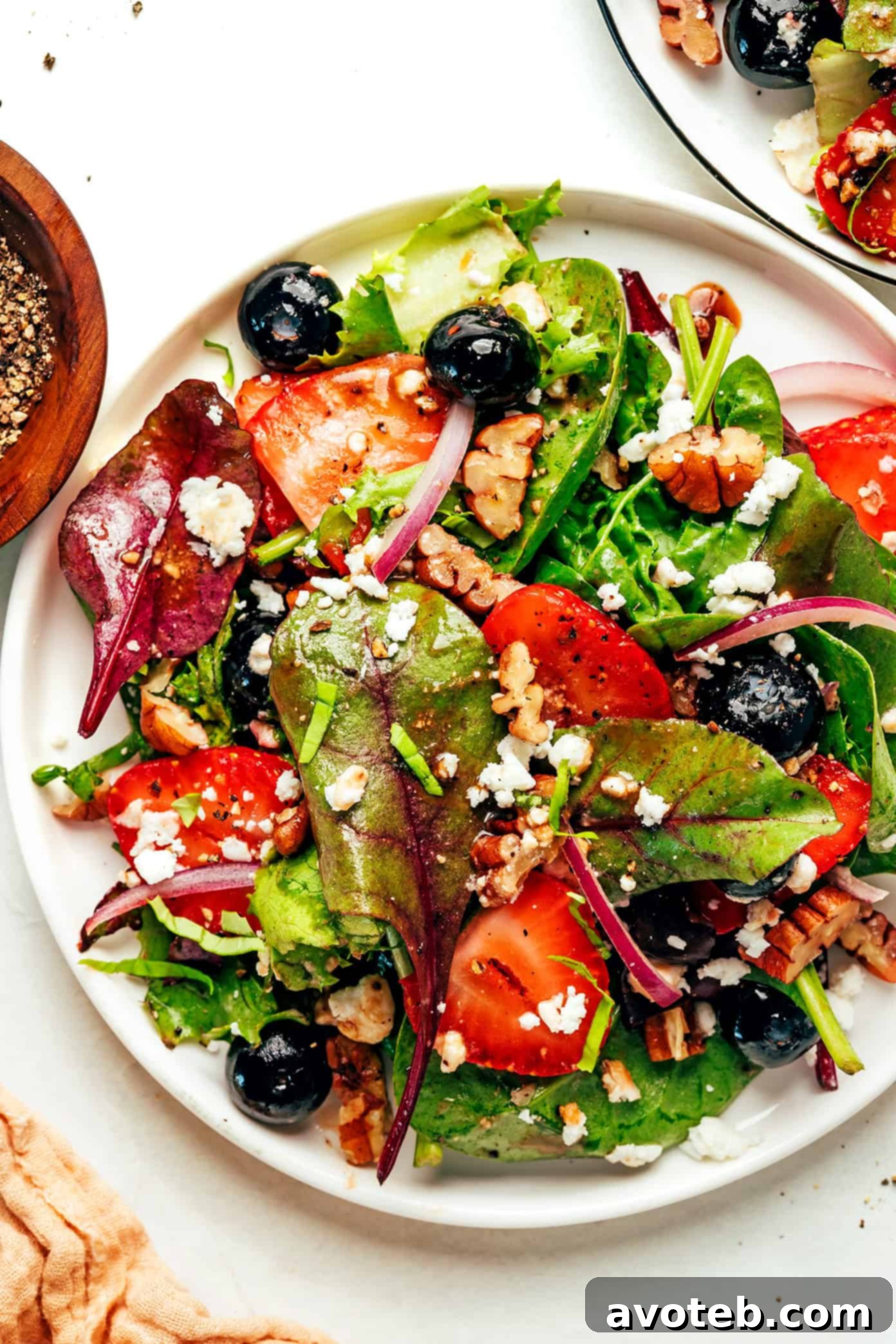 Close-up of fresh balsamic berry spinach salad, showcasing its vibrant ingredients.