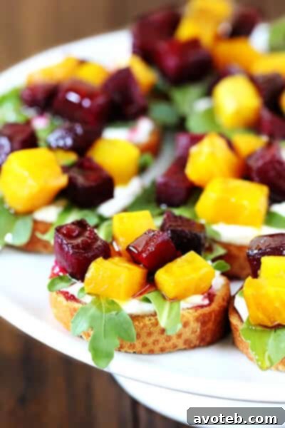 Close-up of a delicious Roasted Beet Crostini with goat cheese, arugula, and honey