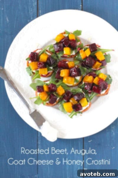 Assortment of colorful Roasted Beet and Arugula Crostini on a serving platter