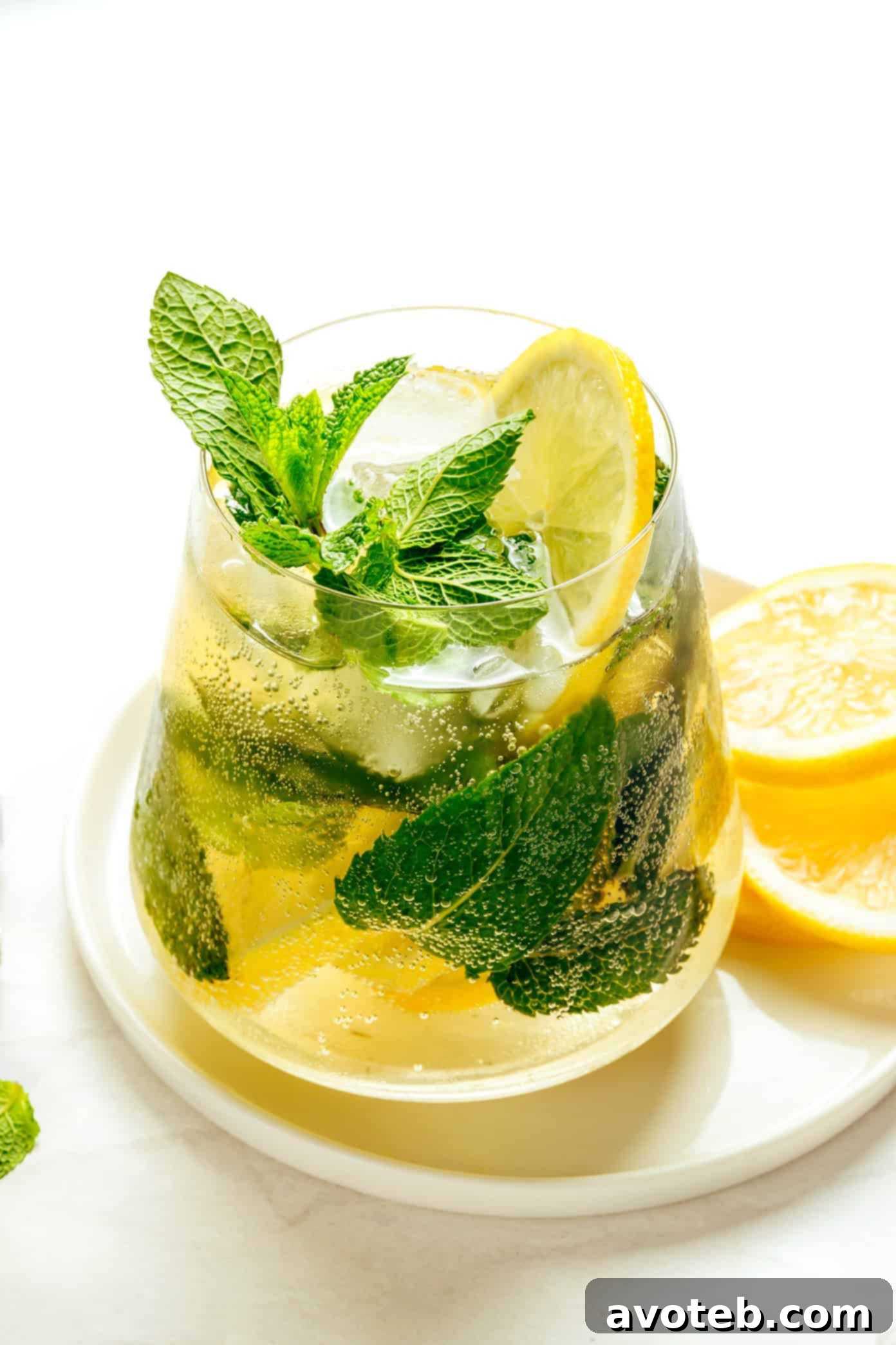 Homemade Hugo Spritz in a wine glass with mint and lemon