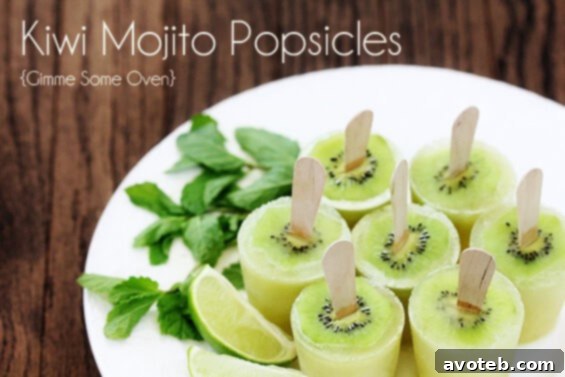 Two hands holding a perfectly frozen Kiwi Mojito Popsicle, showcasing the refreshing green color and the embedded kiwi slice. The background is a soft blur of summer greenery.