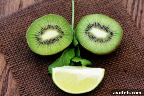 A collection of homemade Kiwi Mojito Popsicles, beautifully arranged on a white plate with scattered fresh mint leaves and lime wedges, emphasizing their natural freshness and appeal.