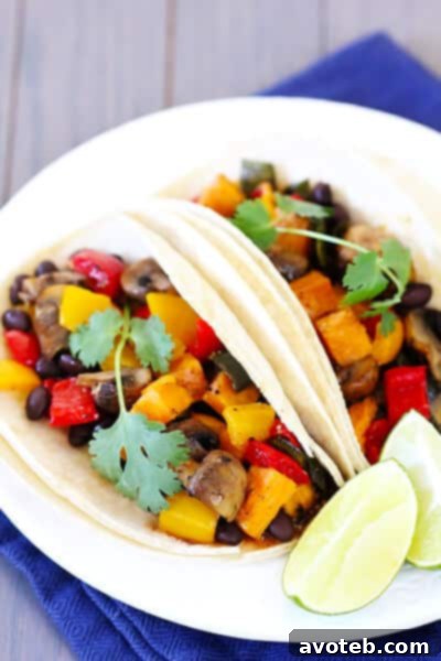 Close-up of a delicious Roasted Vegetable & Black Bean Taco, showing vibrant colors and fresh toppings