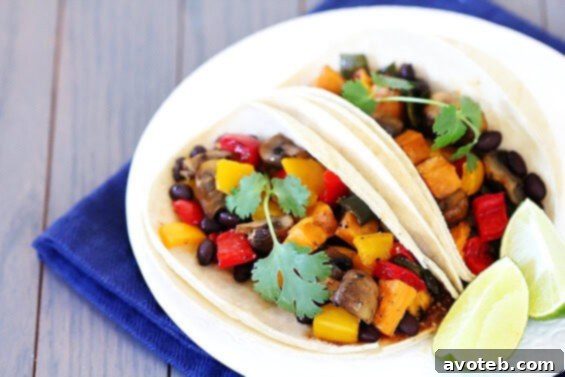 Two hands holding a Roasted Vegetable & Black Bean Taco, ready to eat