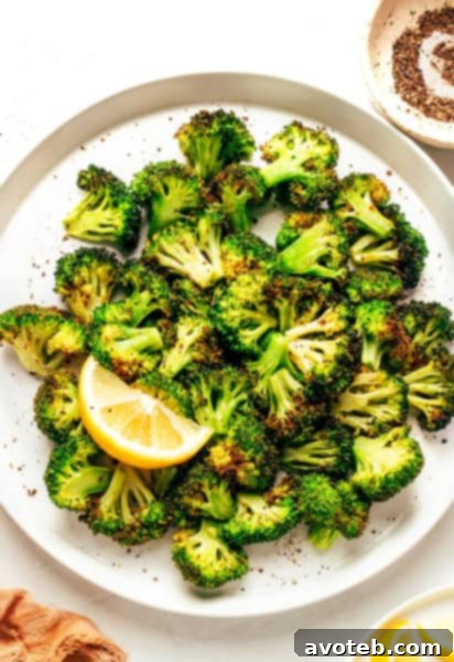 Air Fryer Broccoli served on a plate with lemon.