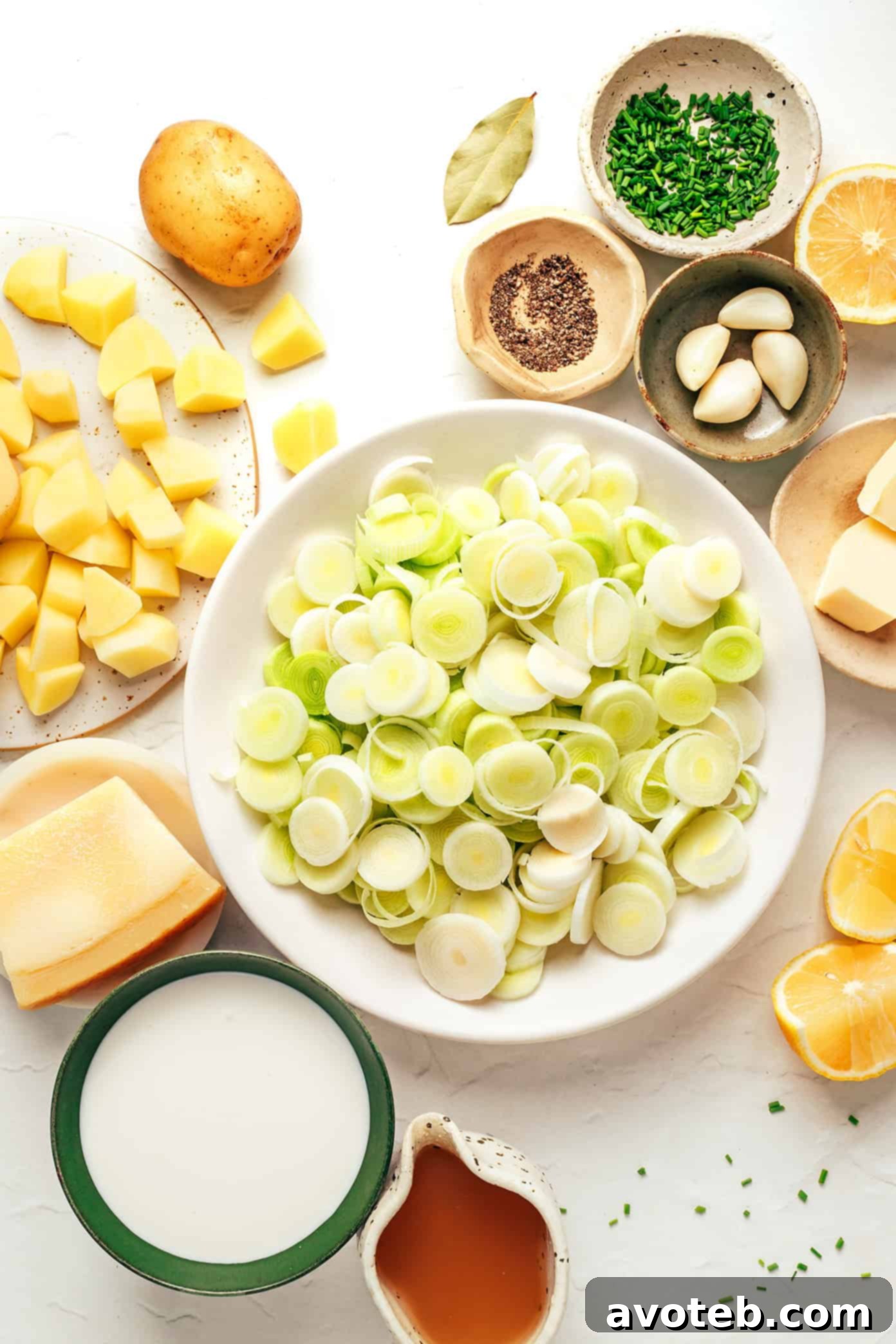 Ingredients for Potato Leek Soup on a wooden cutting board