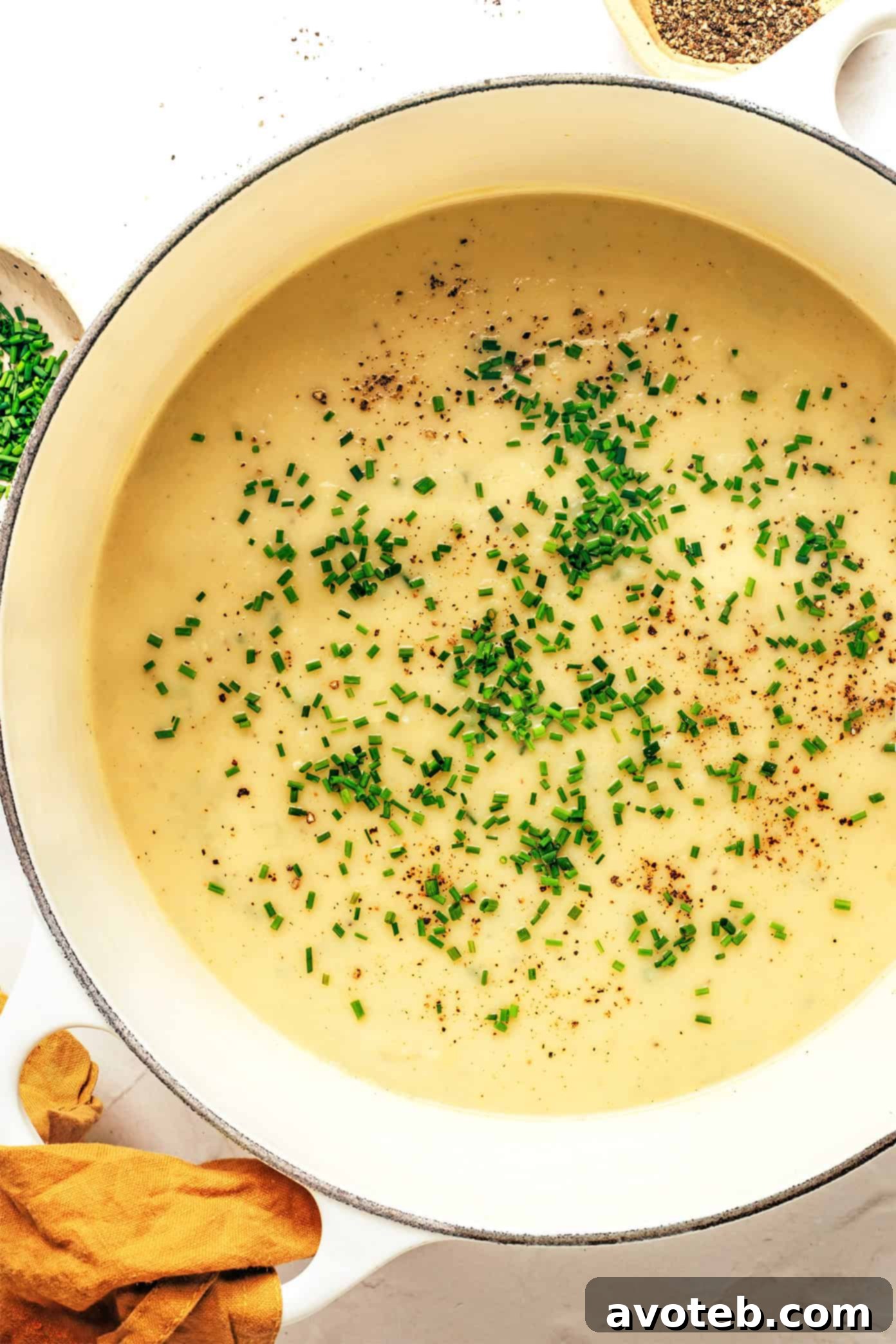 A bowl of creamy potato leek soup garnished with chives