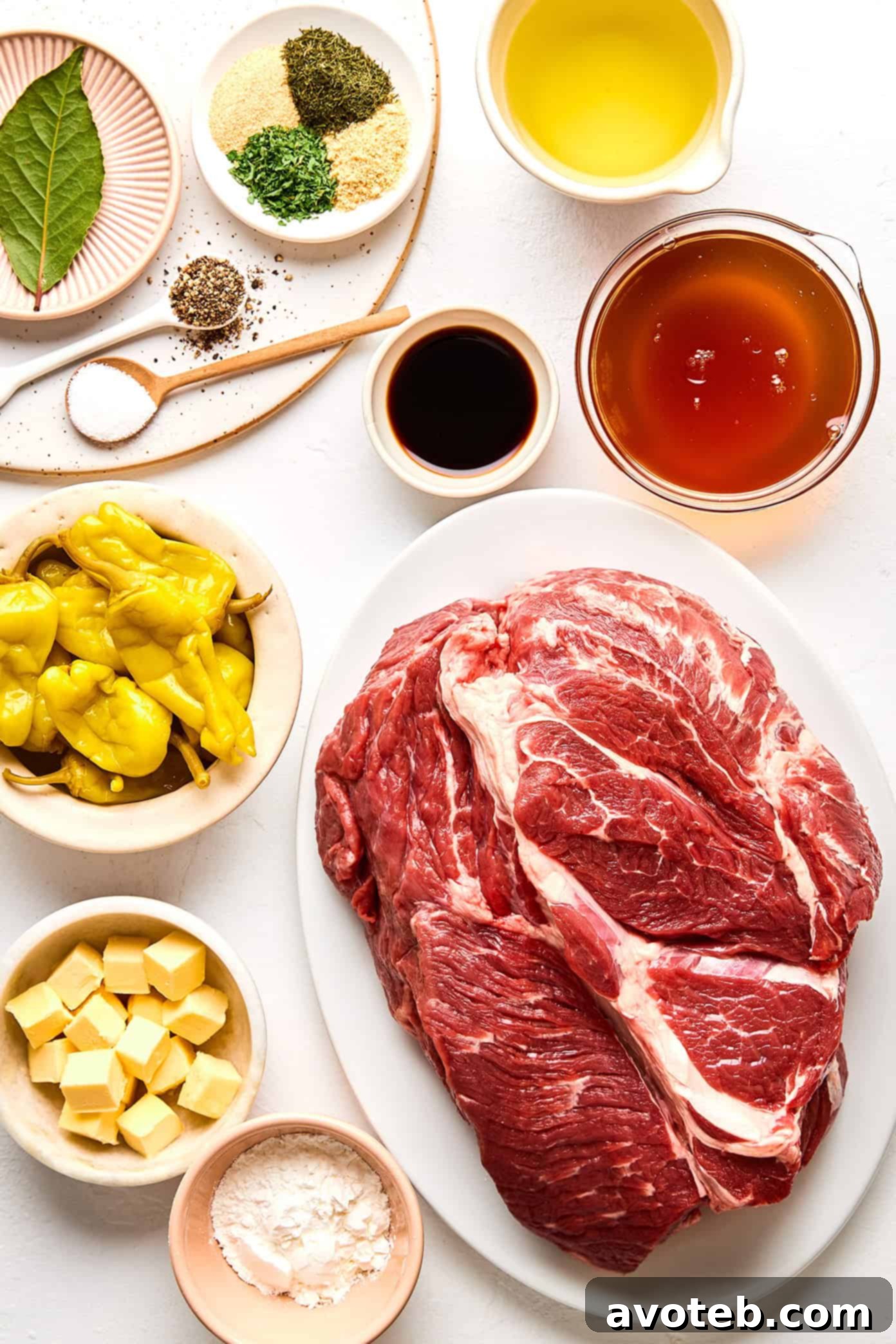 A close-up of shredded Mississippi Pot Roast with visible pepperoncini and herbs, demonstrating its tender texture and rich sauce.