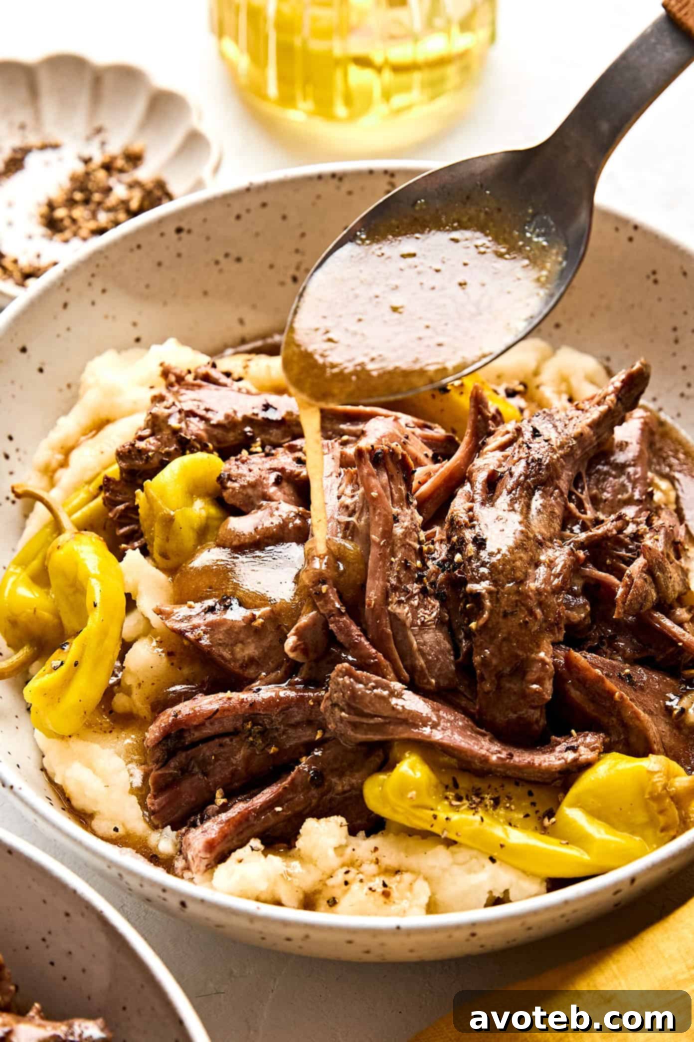 A close-up shot of the finished Mississippi Pot Roast, showcasing the succulent shredded beef and rich, savory sauce, ready for serving.