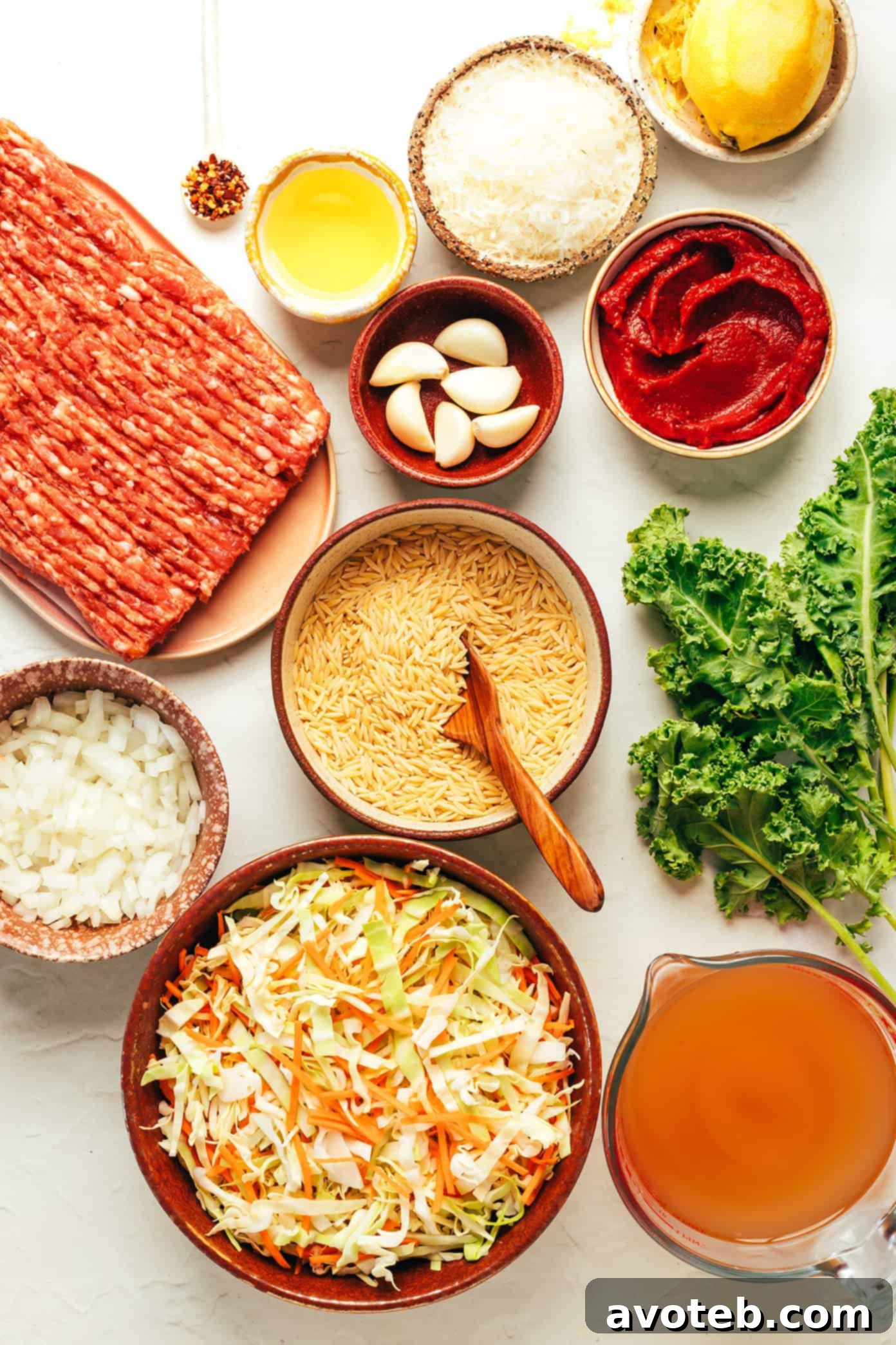 Close-up of the Cabbage Sausage Orzo Soup in a pot, showing the rich broth, sausage, orzo, and wilted cabbage.